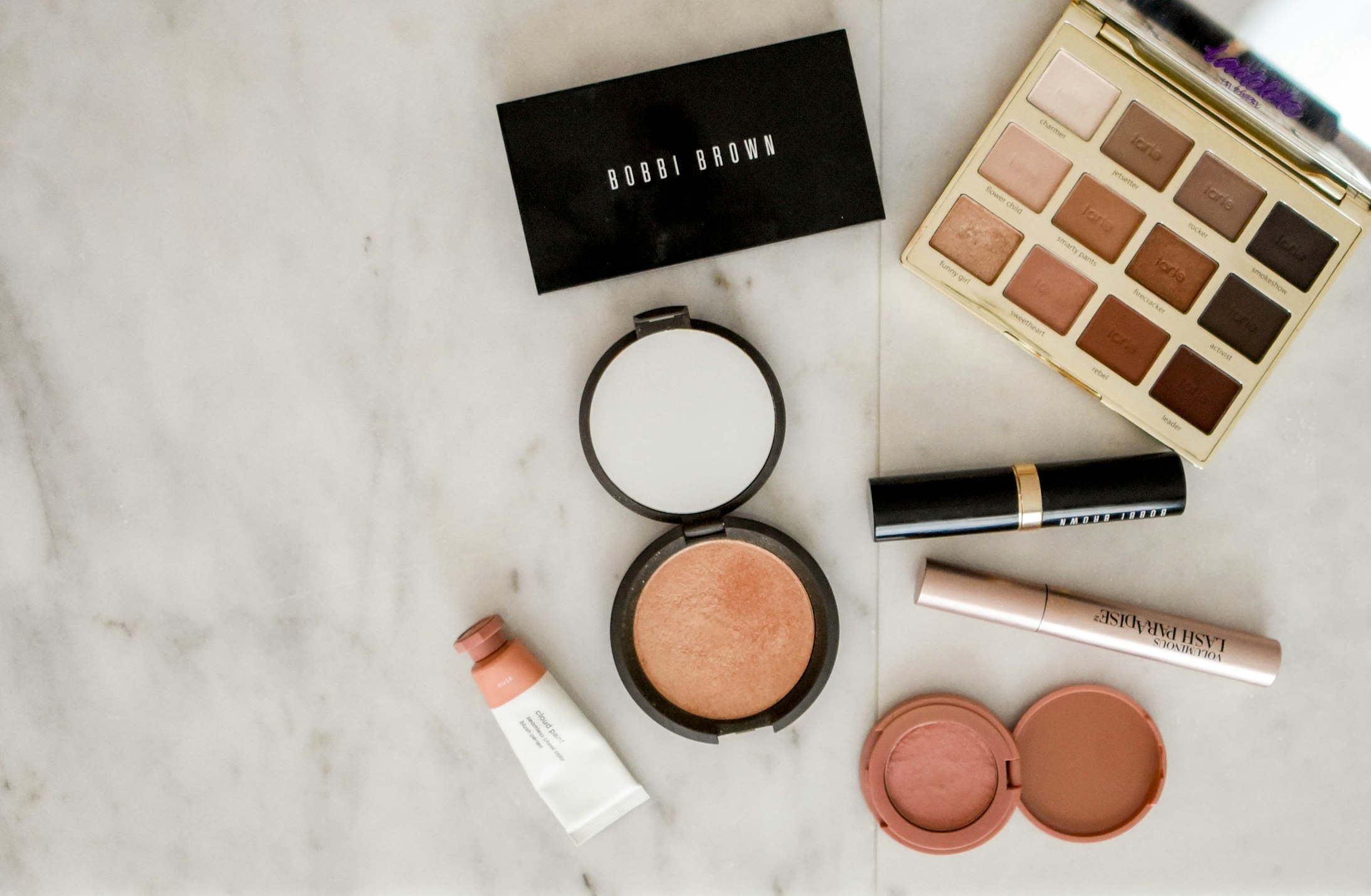 Various foundation bottles and makeup products in different shades for skin tone matching